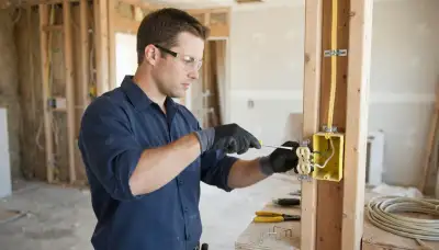 Fresno, CA electrician securing cable runs and landing wire terminals for safe residential electrical wiring