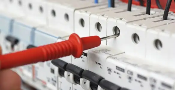 Electrical contractor testing circuit breakers during electrical repair in Madera, CA