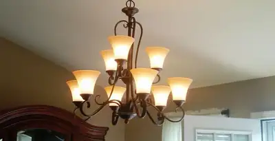 Classic ceiling chandelier installation with warm lighting in Fresno, CA