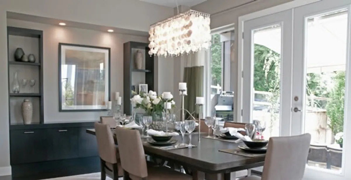 Elegant dining room chandelier installation above table in Fresno, CA