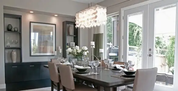 Elegant dining room chandelier installation above table in Fresno, CA