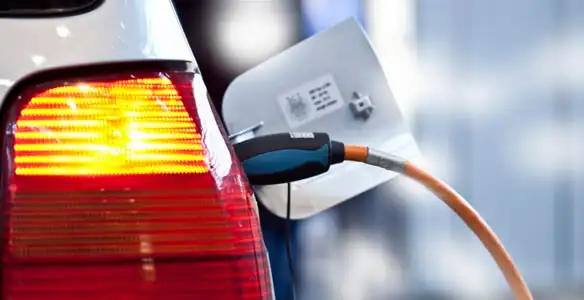 Electric car plugged into EV charger after professional installation in Fresno, CA