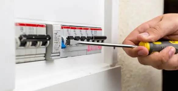 electrical panel upgrade service showing technician adjusting circuit breakers during system upgrade in Fresno, CA