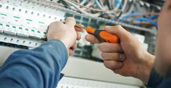 electrical service showing licensed electrician performing electrical panel maintenance and adjustments in Fresno, CA