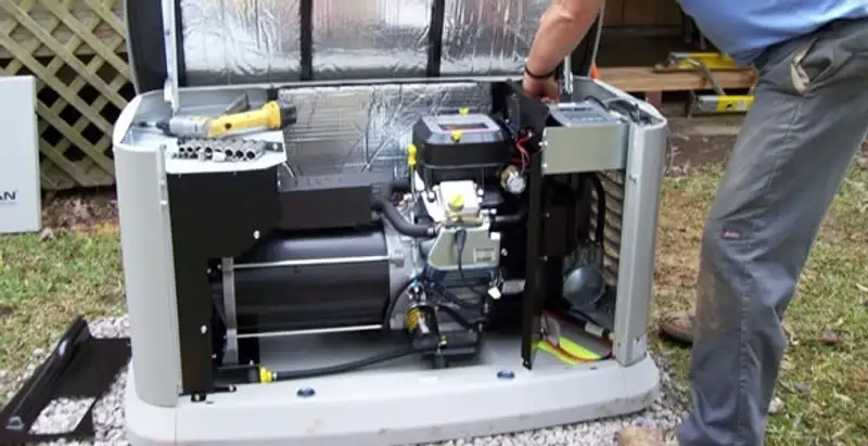 generator installation service showing technician connecting and configuring generator components in Fresno, CA