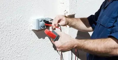 Electrician performing home electrical outlet and wiring inspection in Fresno, CA
