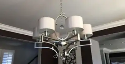 Modern chandelier installation with multiple light fixtures in Fresno, CA