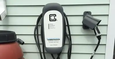 Outdoor electric vehicle charger installation on residential wall in Fresno, CA