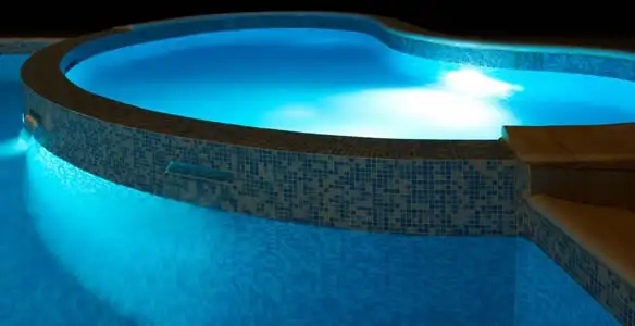 pool light installation and repair services highlighting illuminated pool interior lighting in Fresno, CA