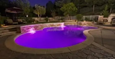 pool light installation and repair services illuminating a residential swimming pool in Fresno, CA