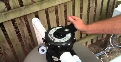 pool pumps service showing professional adjustment of pool pump control system in Fresno, CA