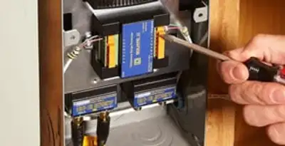 Whole home surge protection device being installed by a licensed electrician to protect electrical systems in Fresno, CA